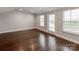 Spacious room featuring hardwood floors and bright natural light from large windows and french door at 11939 Fiddlers Roof Ln, Charlotte, NC 28277