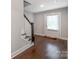 Charming entryway features hardwood floors and staircase with wood banister at 11939 Fiddlers Roof Ln, Charlotte, NC 28277