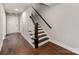 Light-filled entryway featuring hardwood floors and staircase with wood banister at 11939 Fiddlers Roof Ln, Charlotte, NC 28277
