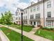 Street view of townhomes featuring manicured lawns, sidewalks, and lamppost lighting at 11939 Fiddlers Roof Ln, Charlotte, NC 28277