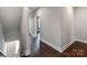 Upstairs hallway with dark hardwood flooring, gray walls, and bright lighting at 11939 Fiddlers Roof Ln, Charlotte, NC 28277