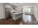 Modern kitchen featuring stainless steel appliances, gray cabinetry, and an island with quartz countertops at 11939 Fiddlers Roof Ln, Charlotte, NC 28277