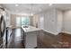 Modern kitchen with stainless appliances, quartz countertops, large island and hardwood floors at 11939 Fiddlers Roof Ln, Charlotte, NC 28277