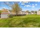 Open backyard with storage shed and mature tree providing shade at 120 Vermillion Loop, Statesville, NC 28625