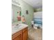 Charming bathroom with striped shower curtain and natural wood vanity at 120 Vermillion Loop, Statesville, NC 28625