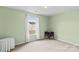 This bedroom features light green walls, carpet and a large window at 120 Vermillion Loop, Statesville, NC 28625