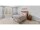 This bedroom features neutral walls, carpet, and large window providing natural light at 120 Vermillion Loop, Statesville, NC 28625