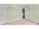 This is a view of a bedroom featuring light green walls, carpet, and a closet at 120 Vermillion Loop, Statesville, NC 28625