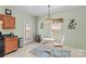 Charming eat-in kitchen featuring chandelier lighting and an exterior door to the back yard at 120 Vermillion Loop, Statesville, NC 28625