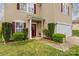 Inviting front entrance with decorative shrubbery and well-maintained walkway at 120 Vermillion Loop, Statesville, NC 28625
