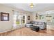 Comfortable living room with hardwood floors, gray sofa, and backyard views at 120 Vermillion Loop, Statesville, NC 28625