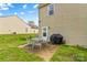 Cozy backyard patio area featuring a table with seating and a grill for outdoor entertaining at 120 Vermillion Loop, Statesville, NC 28625