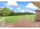 Exterior view from the backyard showcasing a wood deck, expansive lawn, and landscaping at 132 Postell Dr, Statesville, NC 28625
