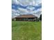 Backyard featuring a well-manicured lawn and a home with a brick exterior and wooden deck at 132 Postell Dr, Statesville, NC 28625