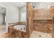 Bathroom with soaking tub, tiled shower, tile flooring, and window at 132 Postell Dr, Statesville, NC 28625