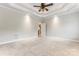 Primary bedroom with tray ceiling, ceiling fan, carpet flooring, and neutral paint at 132 Postell Dr, Statesville, NC 28625
