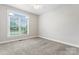 Bright bedroom featuring a ceiling fan, neutral walls, and a large window with blinds at 132 Postell Dr, Statesville, NC 28625