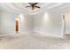 Primary bedroom with tray ceiling, ceiling fan, carpet flooring, and neutral paint at 132 Postell Dr, Statesville, NC 28625