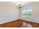 Cozy dining room with hardwood floors, wainscoting and a classic chandelier at 132 Postell Dr, Statesville, NC 28625
