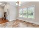 Bright dining area with large windows, beautiful flooring, chandelier, and access to the fireplace at 132 Postell Dr, Statesville, NC 28625