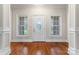Bright foyer with hardwood floors, decorative door with sidelights, and classic white trim at 132 Postell Dr, Statesville, NC 28625