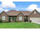 Charming single-story brick home featuring a manicured front lawn and an attached two-car garage at 132 Postell Dr, Statesville, NC 28625