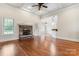 Inviting living room with hardwood floors, stone fireplace, and an open layout at 132 Postell Dr, Statesville, NC 28625
