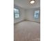 Spacious bedroom features neutral carpet and dual windows for ample natural light at 1421 Van Nuys St, Salisbury, NC 28144