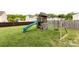 A wooden playset features a slide, a climbing wall, a swing, and an adjacent privacy fence at 15225 Kissimmee Ln, Mint Hill, NC 28227