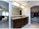 Bathroom featuring a double sink vanity with granite countertops and access to the bedroom and walk-in closet at 15225 Kissimmee Ln, Mint Hill, NC 28227