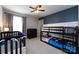 Bedroom with blue accent wall, a crib, a dresser, and a bunk bed at 15225 Kissimmee Ln, Mint Hill, NC 28227