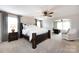 Primary bedroom boasts a large bed, a sitting area, and plush carpeting for ultimate comfort at 15225 Kissimmee Ln, Mint Hill, NC 28227