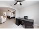 Bright bedroom showcasing a dark wood desk and arched doorway to a beautifully furnished bed and seating area at 15225 Kissimmee Ln, Mint Hill, NC 28227