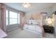 Bright bedroom featuring a canopy bed and whimsical decor, with ample natural light from a large window at 15225 Kissimmee Ln, Mint Hill, NC 28227