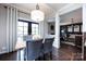 Inviting dining area with gray upholstered chairs, hardwood floors, and natural light at 15225 Kissimmee Ln, Mint Hill, NC 28227