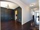 Dining room featuring dark wood floors, elegant black paneled walls, and modern light fixture at 15225 Kissimmee Ln, Mint Hill, NC 28227