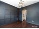Dining room features paneled accent walls, hardwood floors, and modern light fixture at 15225 Kissimmee Ln, Mint Hill, NC 28227