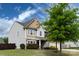 Two-story home with a two-car garage, complemented by a lush green lawn at 15225 Kissimmee Ln, Mint Hill, NC 28227