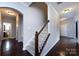 Bright foyer with staircase, hardwood floors, and arched doorways to the rest of the house at 15225 Kissimmee Ln, Mint Hill, NC 28227