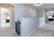 Bright hallway with neutral tones and a view of bedrooms at either end at 15225 Kissimmee Ln, Mint Hill, NC 28227