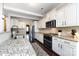 Bright kitchen features granite countertops, stainless appliances, and white cabinetry at 15225 Kissimmee Ln, Mint Hill, NC 28227