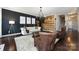 Cozy living room with wood-accented wall, hardwood floors, and comfortable seating at 15225 Kissimmee Ln, Mint Hill, NC 28227