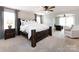 Bright main bedroom with a large bed, neutral tones, and a connected office space at 15225 Kissimmee Ln, Mint Hill, NC 28227