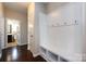 Well-lit mudroom features built-in bench with storage and convenient coat hooks at 15225 Kissimmee Ln, Mint Hill, NC 28227