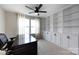 Office boasts built-in shelving, cabinets, and a large window with natural light for a comfortable work environment at 15225 Kissimmee Ln, Mint Hill, NC 28227