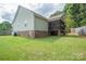 Backyard featuring a screened porch and grassy lawn, perfect for outdoor enjoyment at 1812 Sam Smith Rd, Fort Mill, SC 29708