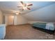 Cozy carpeted bedroom with ceiling fans, closet, and natural light from the window at 1812 Sam Smith Rd, Fort Mill, SC 29708