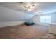 Cozy carpeted bedroom with ceiling fans and natural light from the window at 1812 Sam Smith Rd, Fort Mill, SC 29708