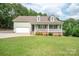 Charming home with a covered front porch, two-car garage, and beautifully landscaped yard at 1812 Sam Smith Rd, Fort Mill, SC 29708