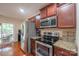 Kitchen showcases stainless steel appliances, granite countertops, and wood floors at 1812 Sam Smith Rd, Fort Mill, SC 29708